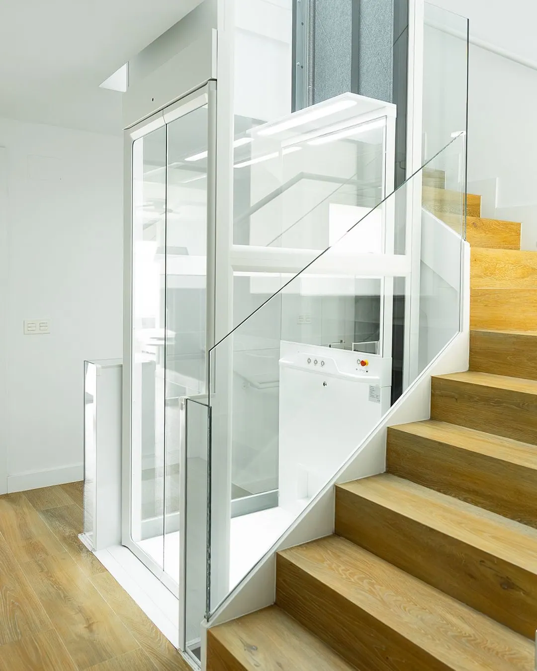 Ascensor Aritco HomeLift Compact de cristal en blanco · Vivienda unifamiliar con escalera de madera en Boadilla del Monte · vista general