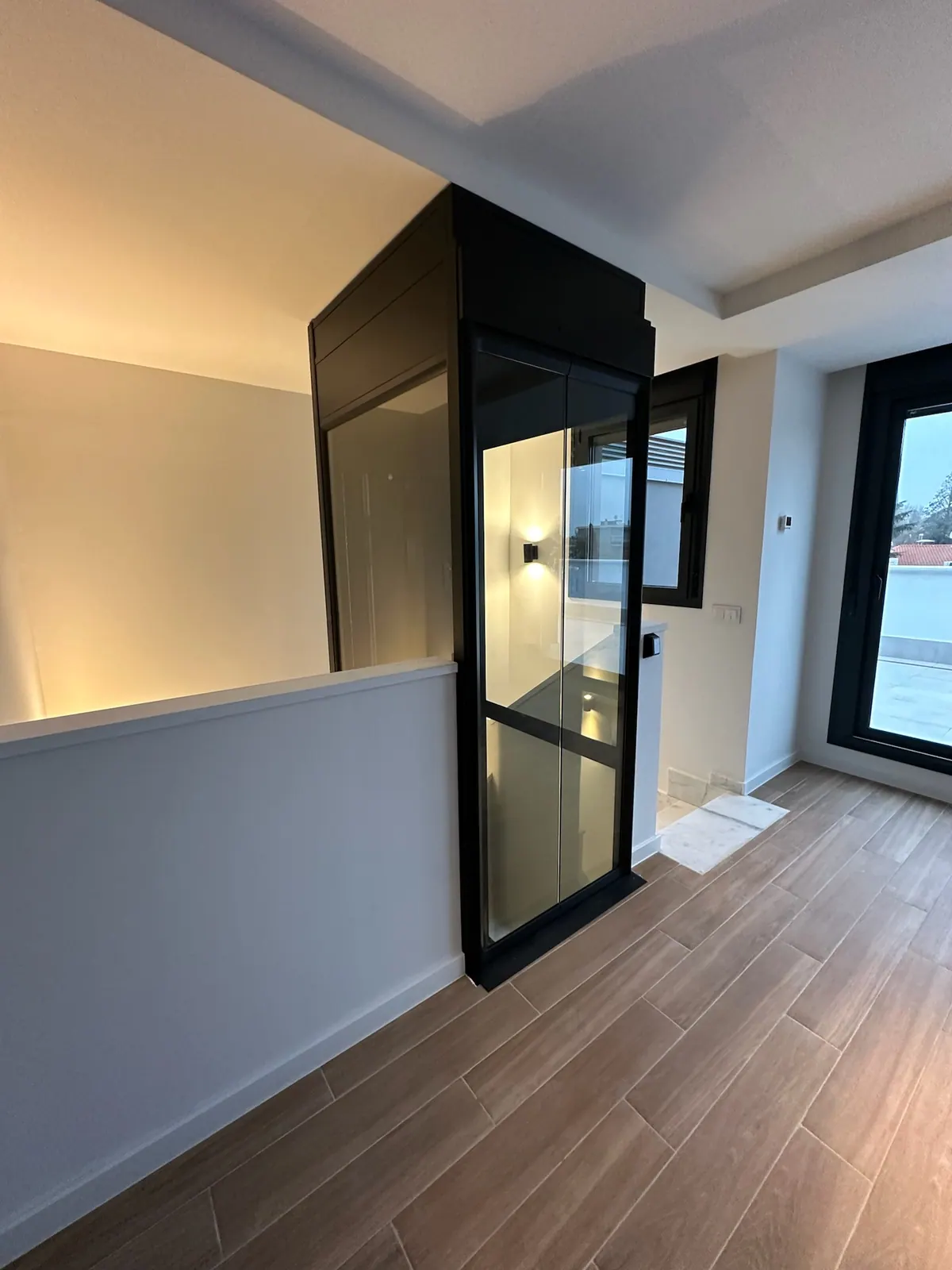 Ascensor Aritco HomeLift Compact de cristal y paneles en negro · Vivienda unifamiliar en Madrid con ascensor negro · vista general