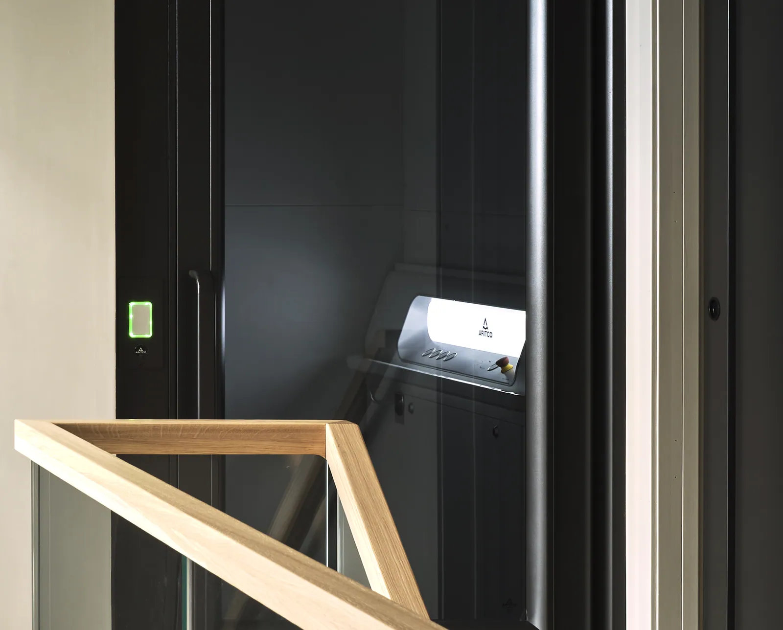 Ascensor Aritco HomeLift Access de paneles opacos en negro · Vivienda unifamiliar contemporánea con suelos de roble · detalle